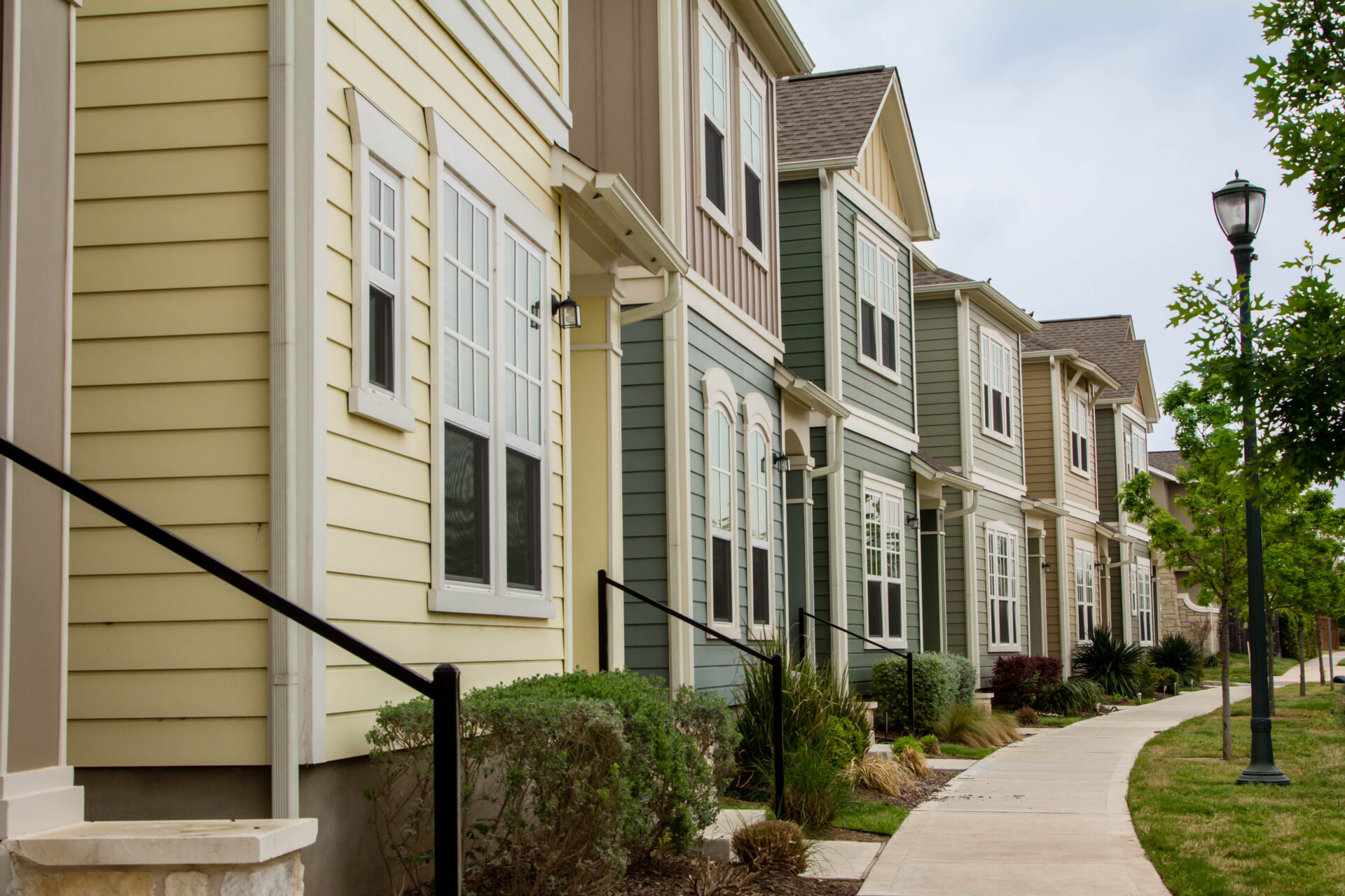 A series of homes with solar panels on their roofs that could benefit from property management in Austin